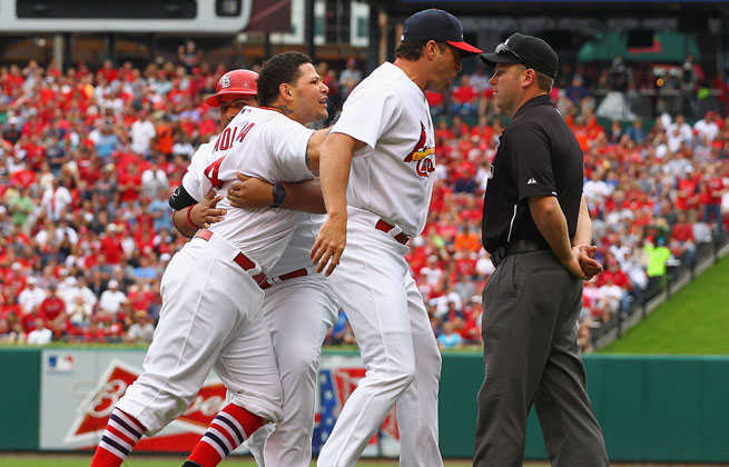 Yadier Molina (left) was suspended one game and fined for bumping umpire Mike Everitt during an argument Sunday.